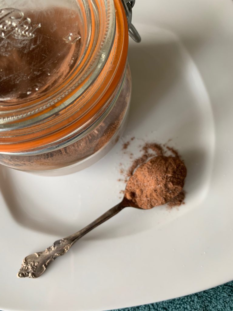 Jar and spoon of hot cocoa mix